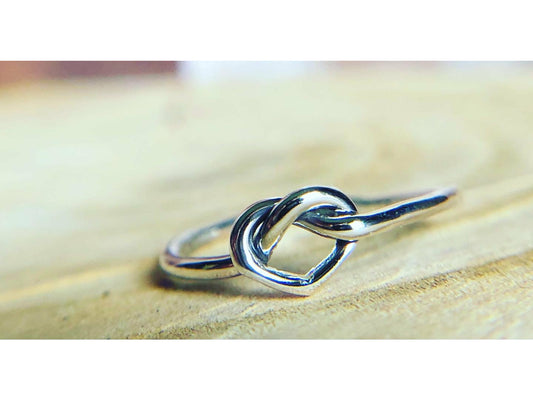 small heart formed out of silver, one continous piece of silver.