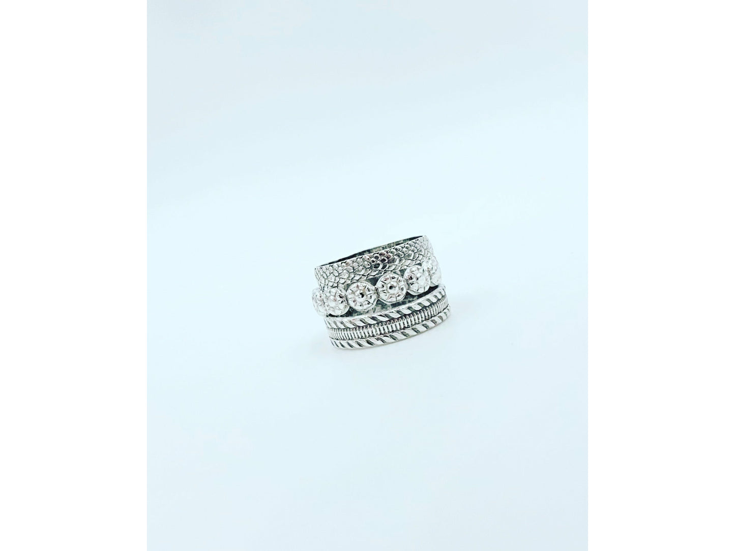 three different band to layer together, top band is snakeskins print, middle band is flowers, bottom is braided silver