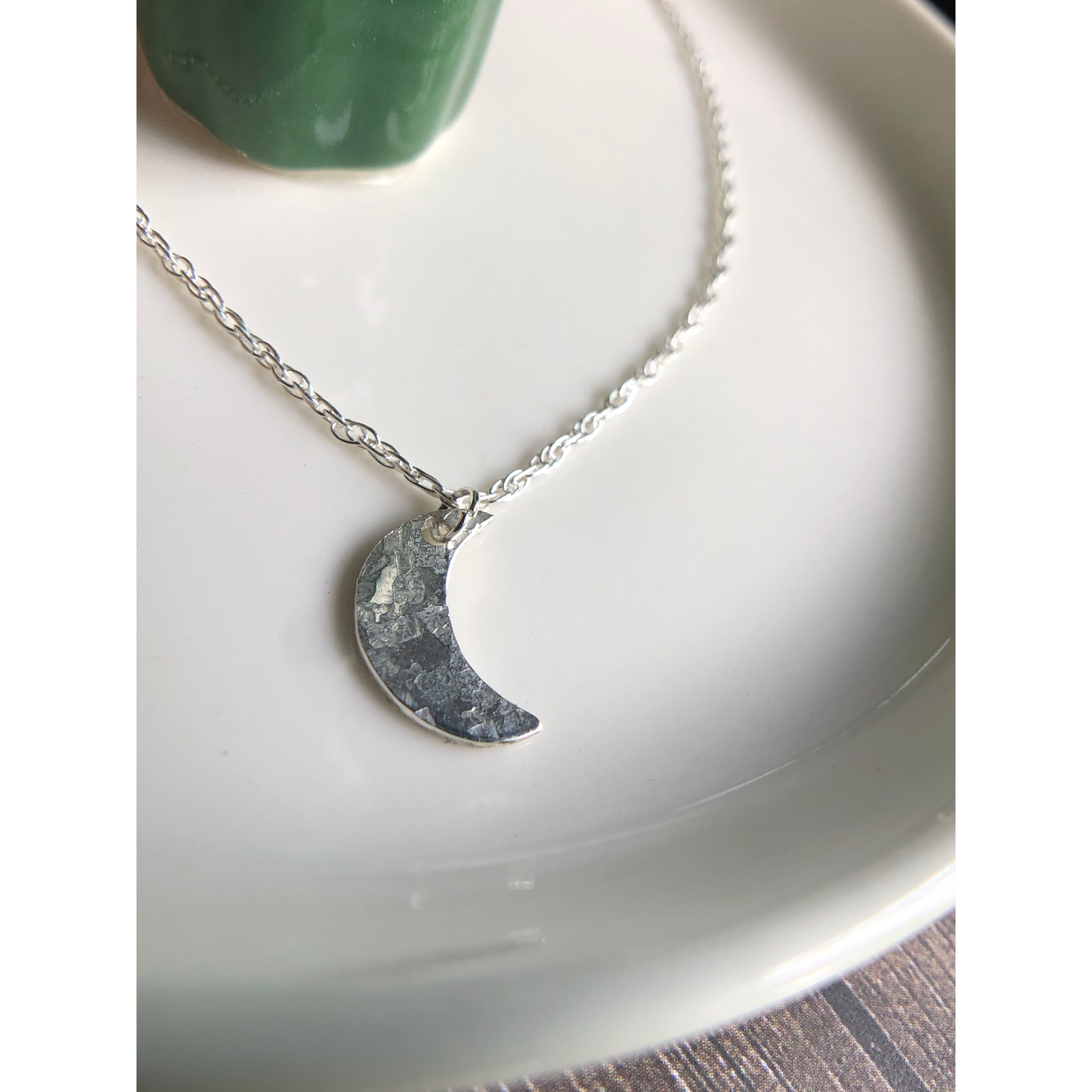 Simple silver chain with sterling silver cut moon mounted on the middle