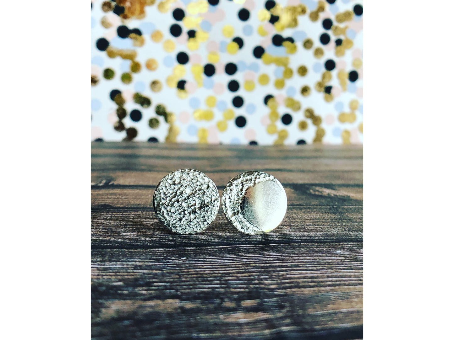 Circle pieces of silver with a crescent moon textured into each earrings. Center post