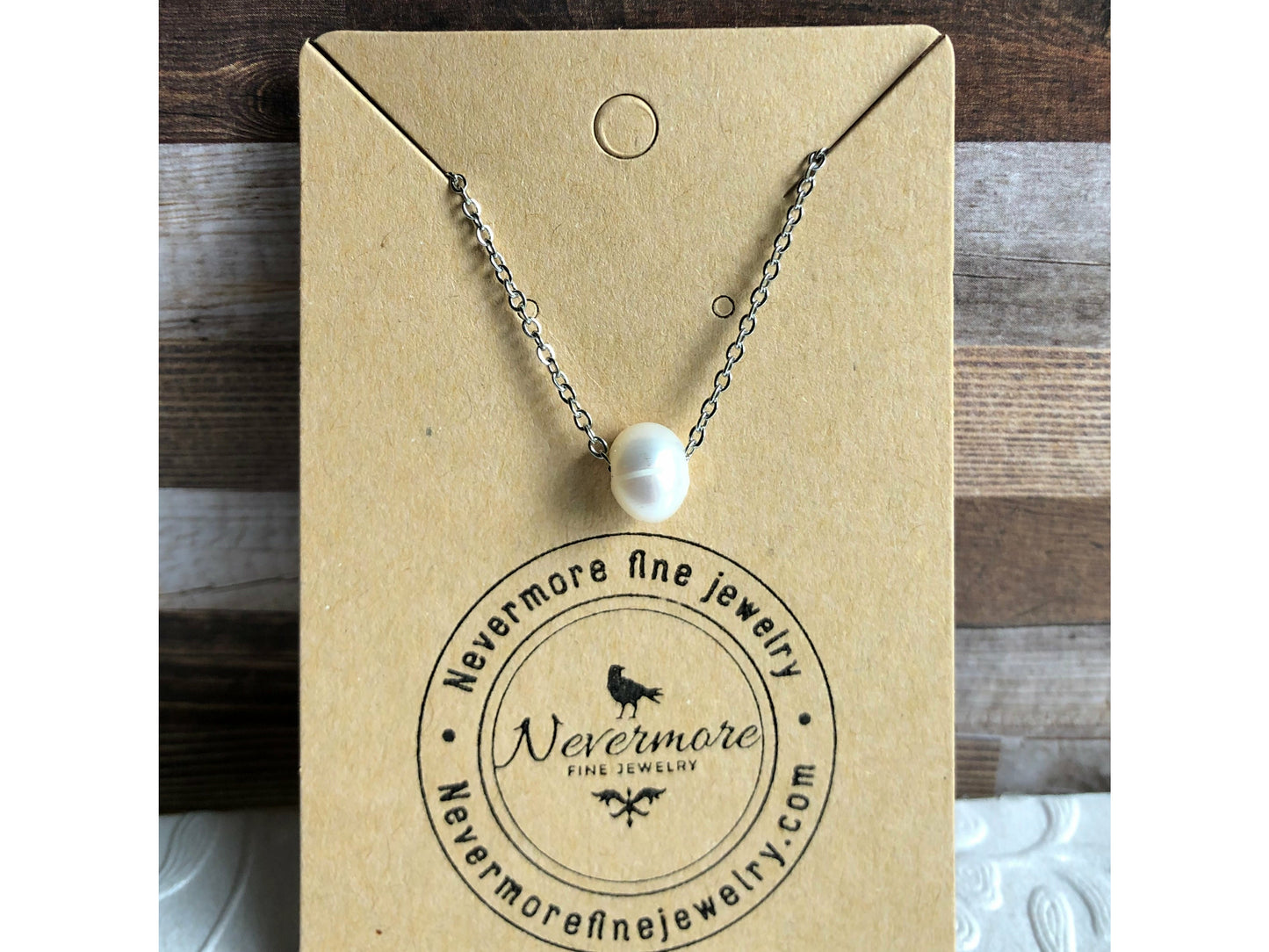 Small simple pearl with the chain of the necklace fed through it