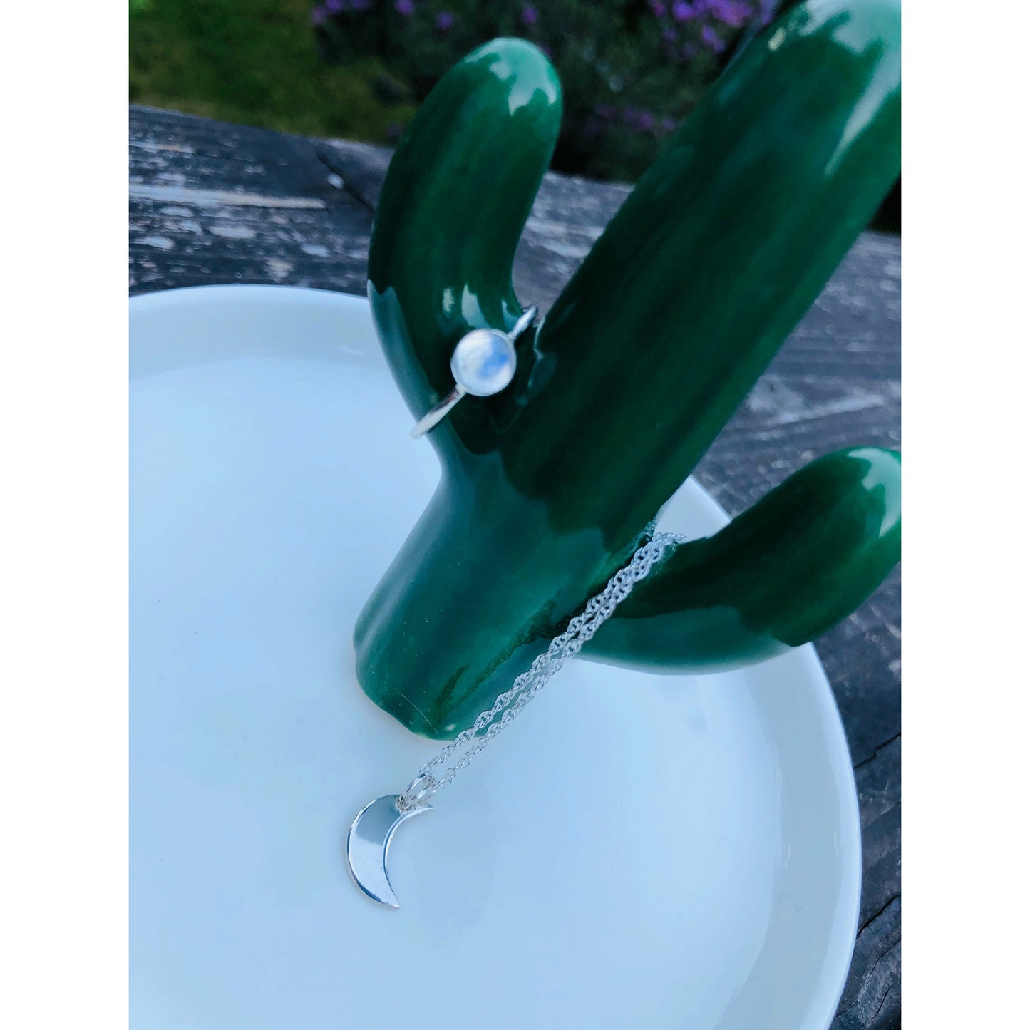 Small sliver of a moon mounted on a stainless steel chain
