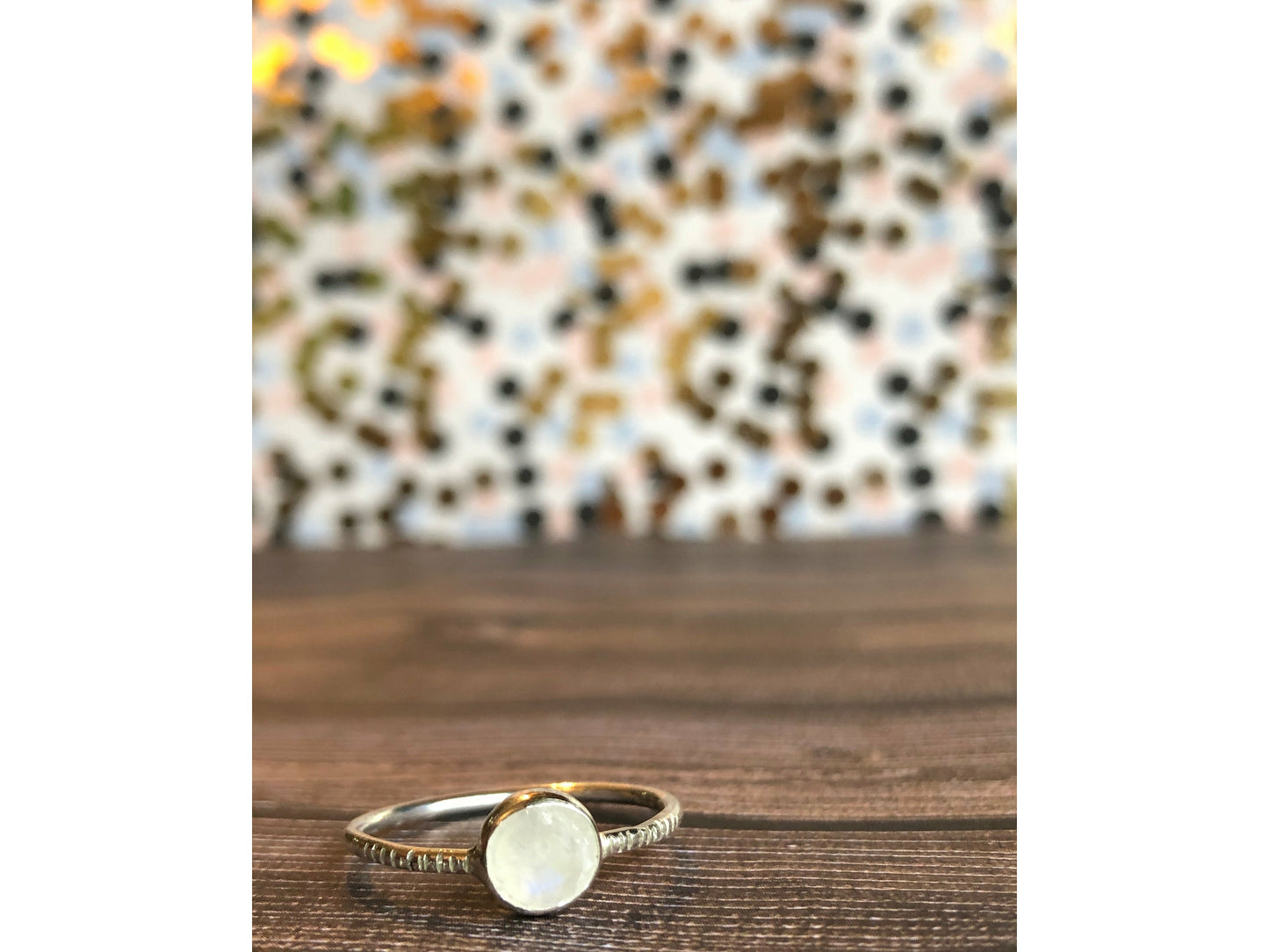 small moonstone ring with simple band. Bezel set.