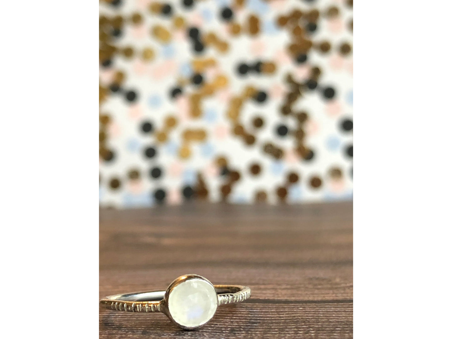 small moonstone ring with simple band. Bezel set.