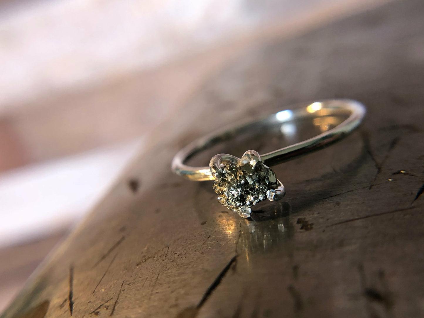 Small single band ring with raw pyrite prong set