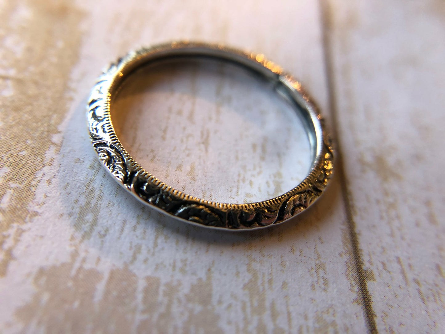 Small ring with one band with swirl inlay, perfect for stacking.