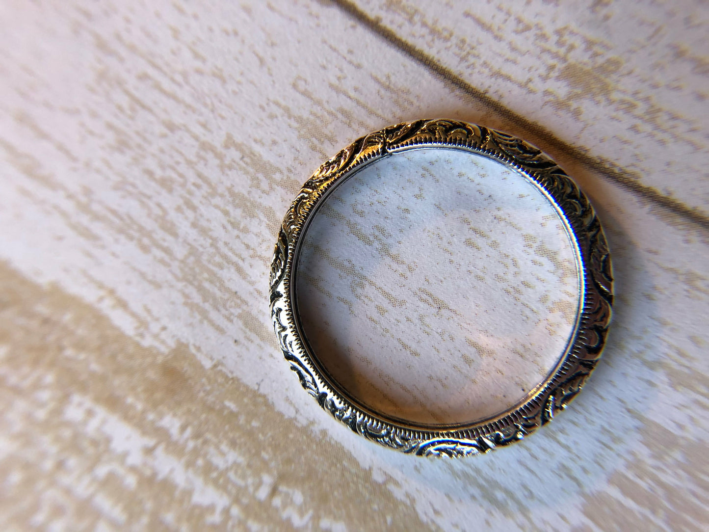 Small ring with one band with swirl inlay, perfect for stacking.