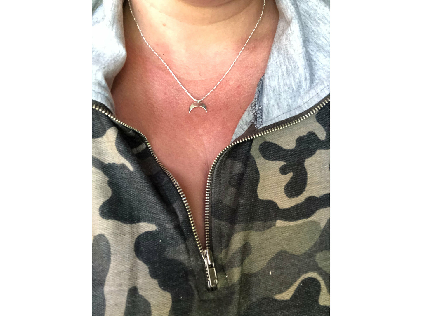 Sterling silver moon shape pointed downward mounted on a stainless steel chain