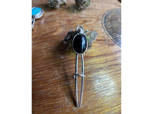 Black two prong hair fork with onyx set upon the top.