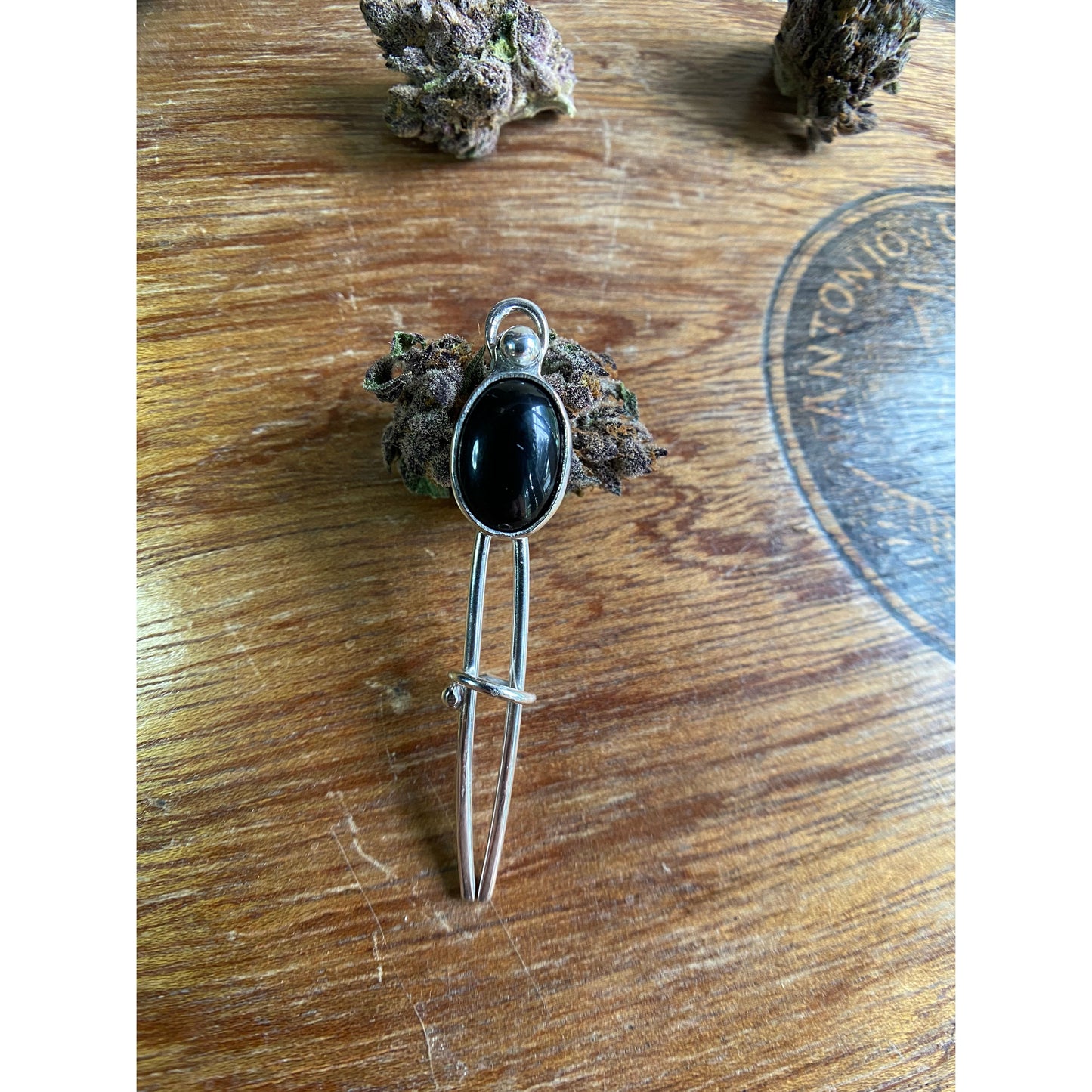 Black two prong hair fork with onyx set upon the top.