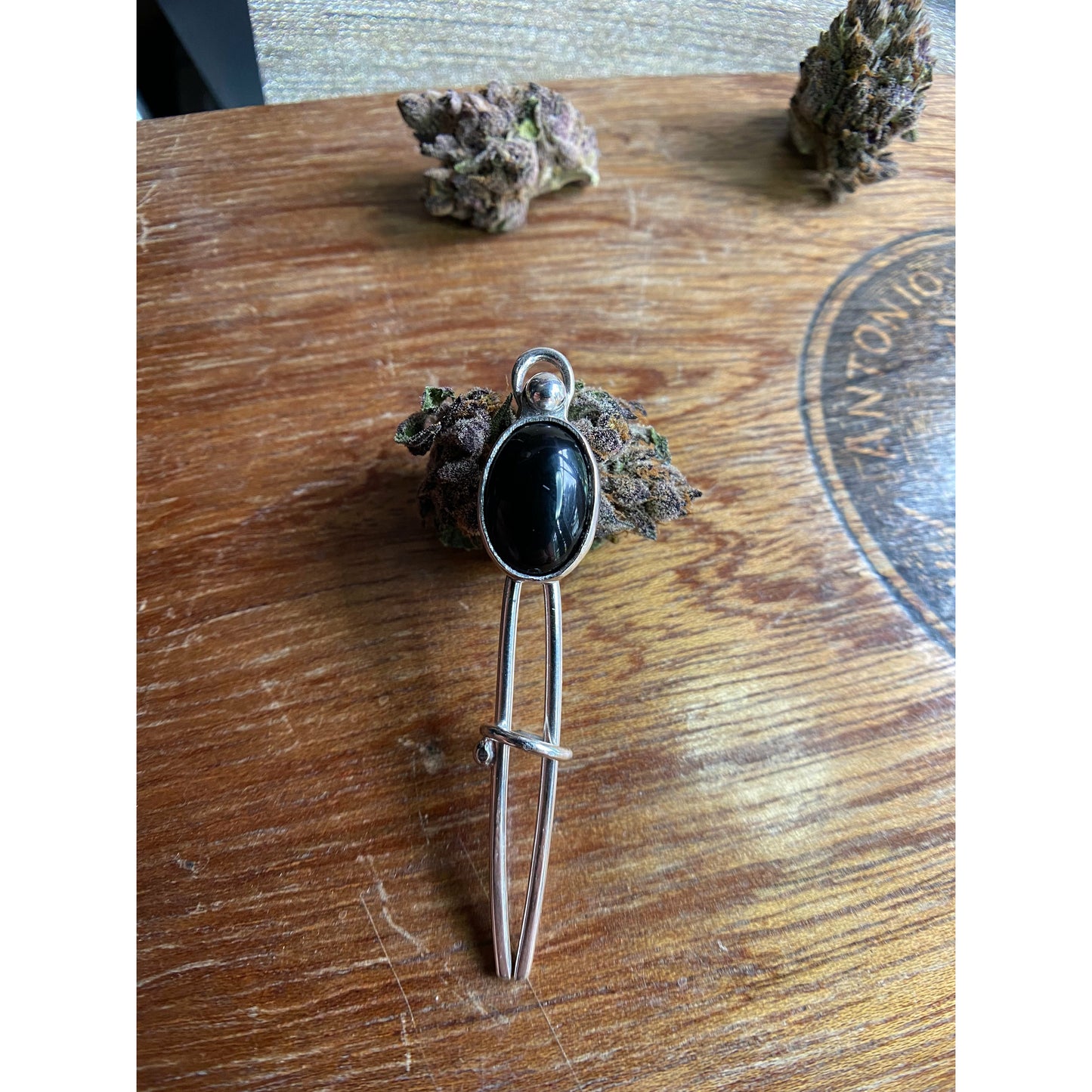 Black two prong hair fork with onyx set upon the top.