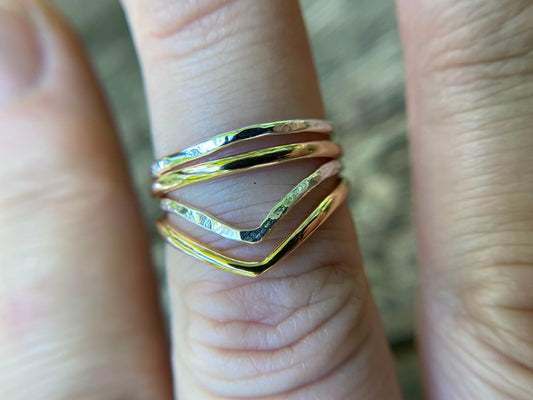 Silver and gold simple rings stacked upon a chevron shaped ring. Perfecting stacking set for a simple forward look.