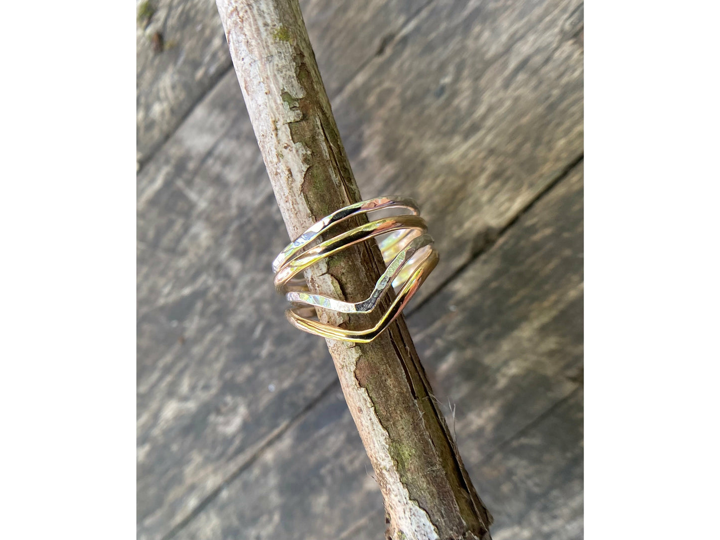 Silver and gold simple rings stacked upon a chevron shaped ring. Perfecting stacking set for a simple forward look.