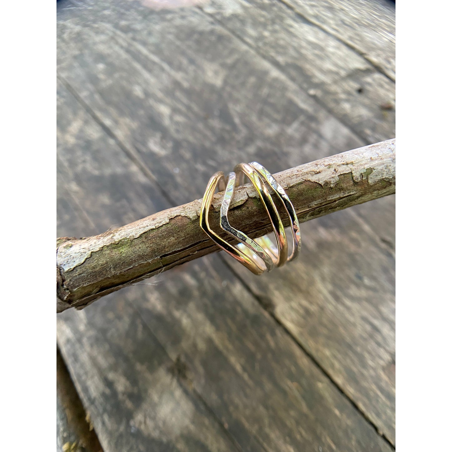 Silver and gold simple rings stacked upon a chevron shaped ring. Perfecting stacking set for a simple forward look.