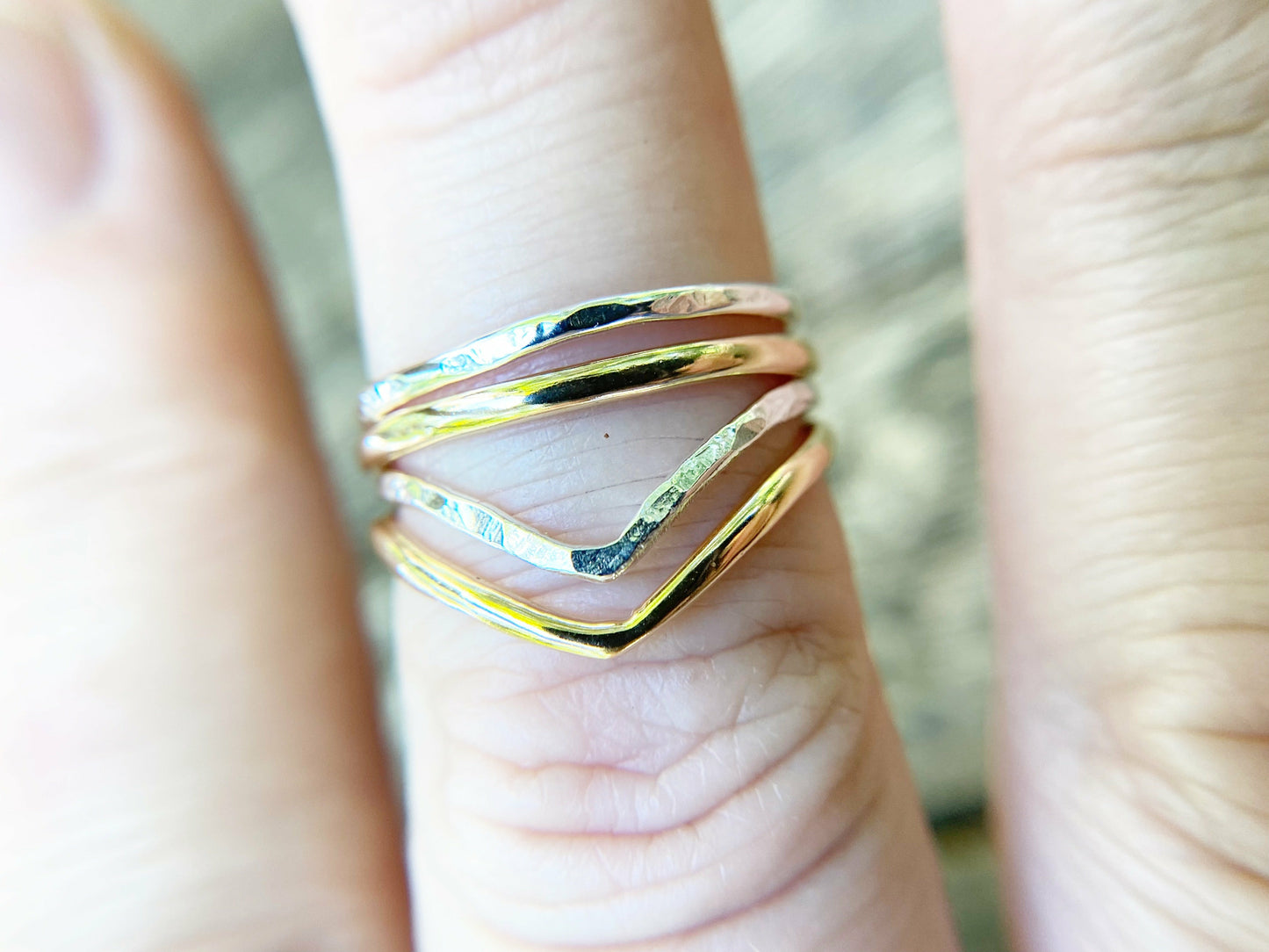 Silver and gold simple rings stacked upon a chevron shaped ring. Perfecting stacking set for a simple forward look.