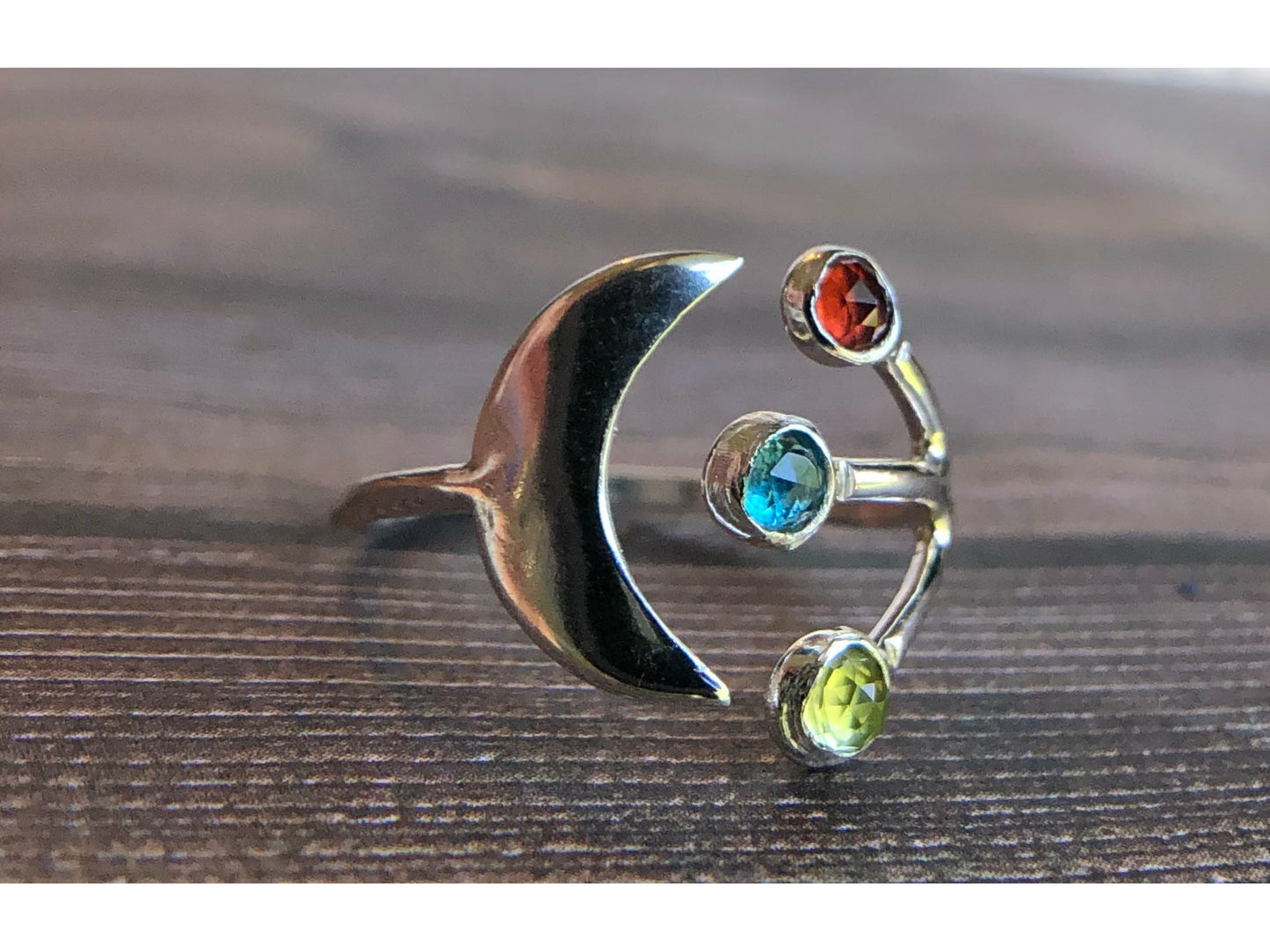 Adjustable ring with moon on one side and three stones of your choice on the opposite band.