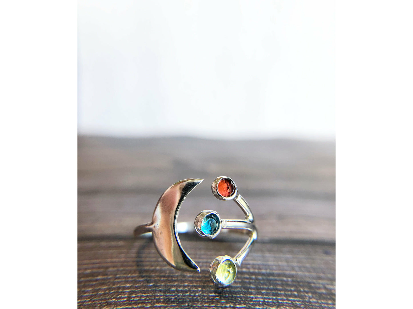 Adjustable ring with moon on one side and three stones of your choice on the opposite band.