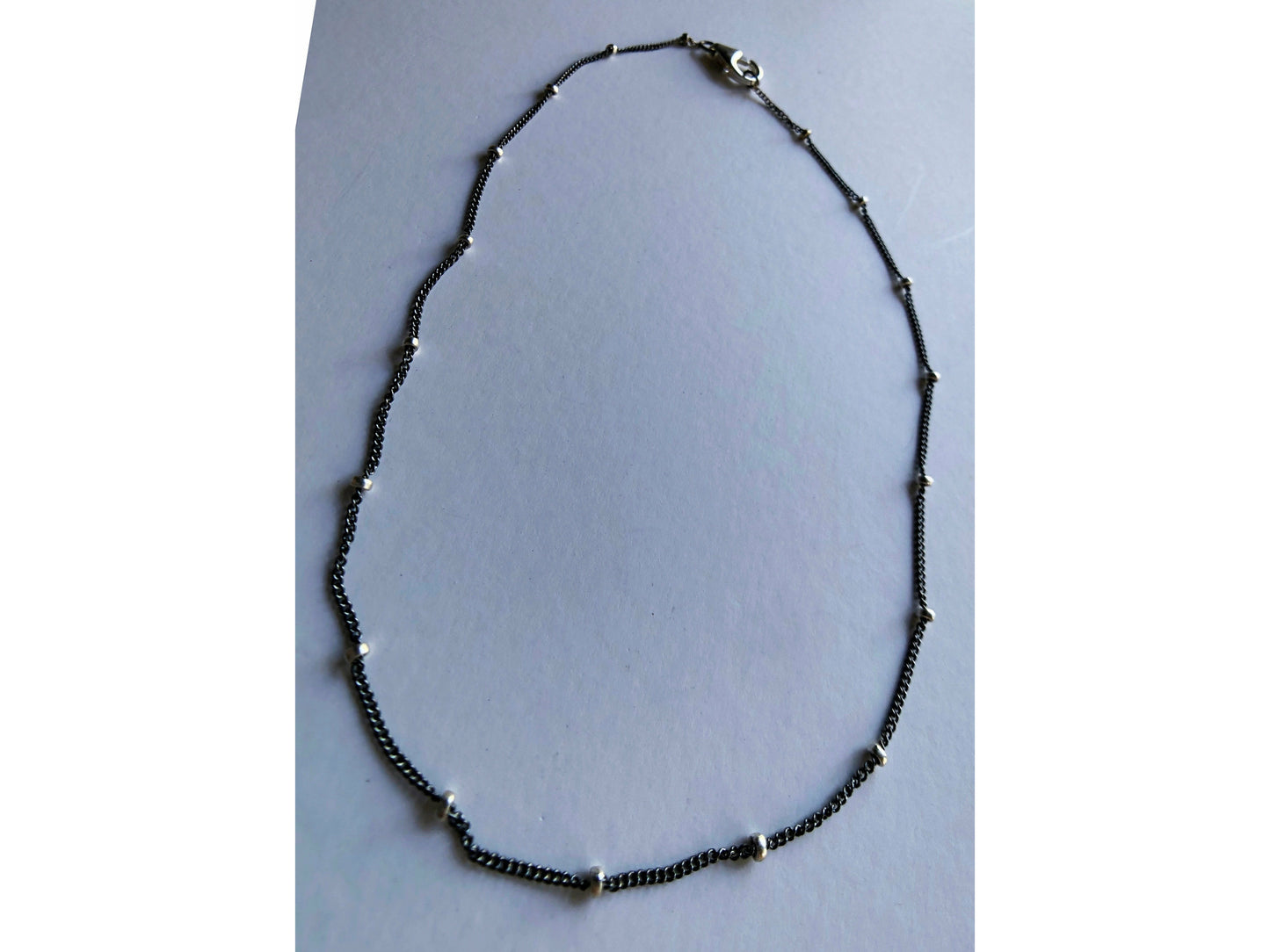 Small black bracelet with dots of silver.