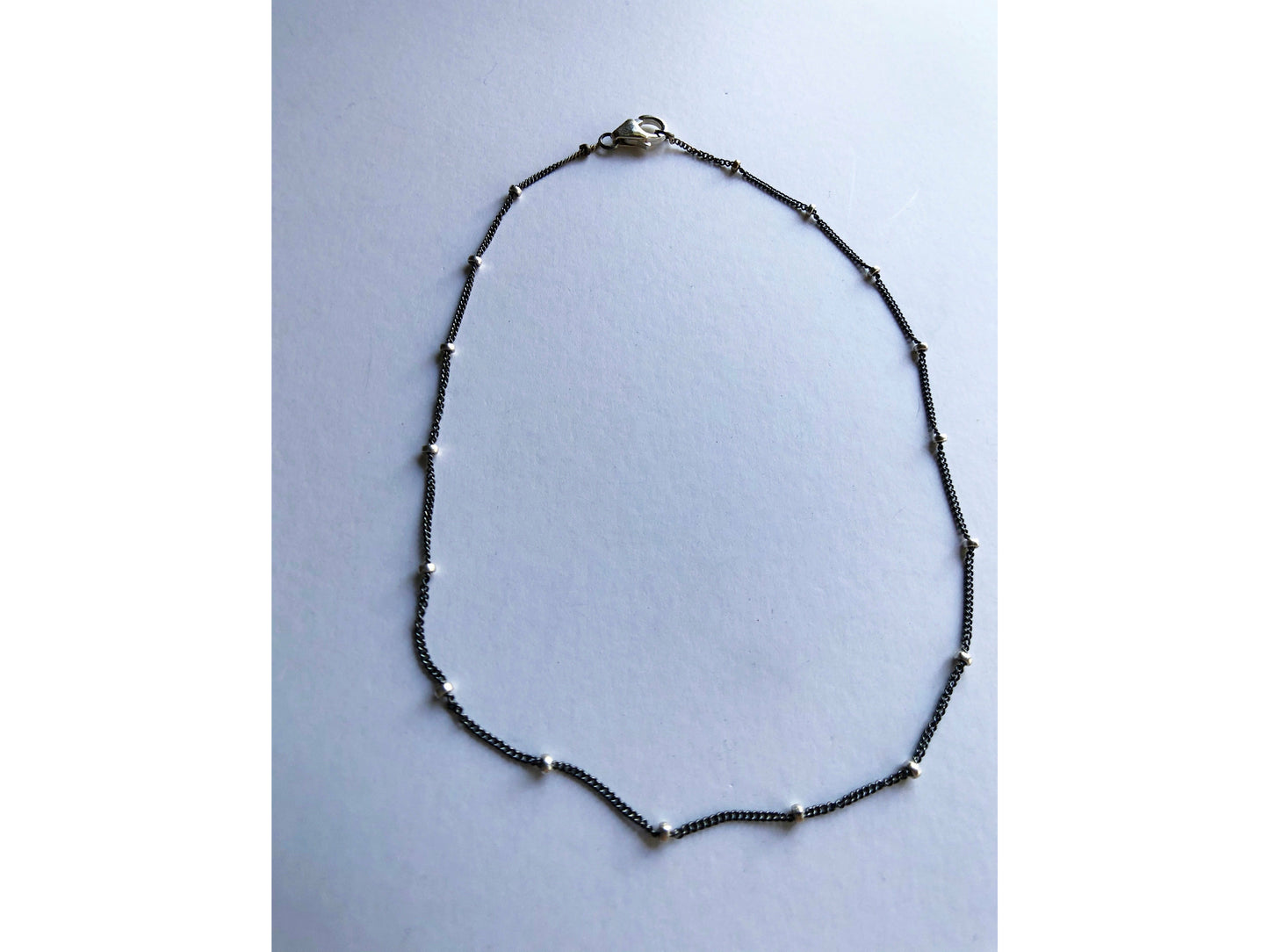 Small black bracelet with dots of silver.
