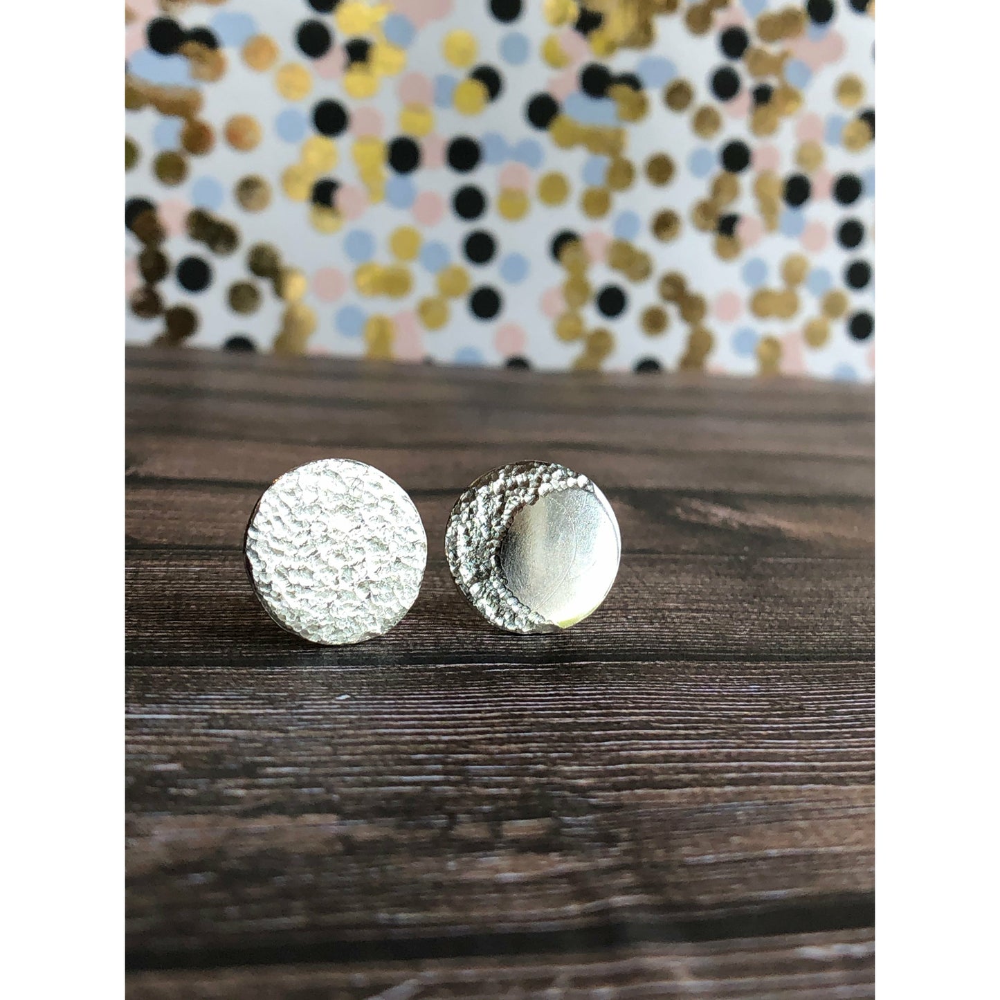 Circle pieces of silver with a crescent moon textured into each earrings. Center post