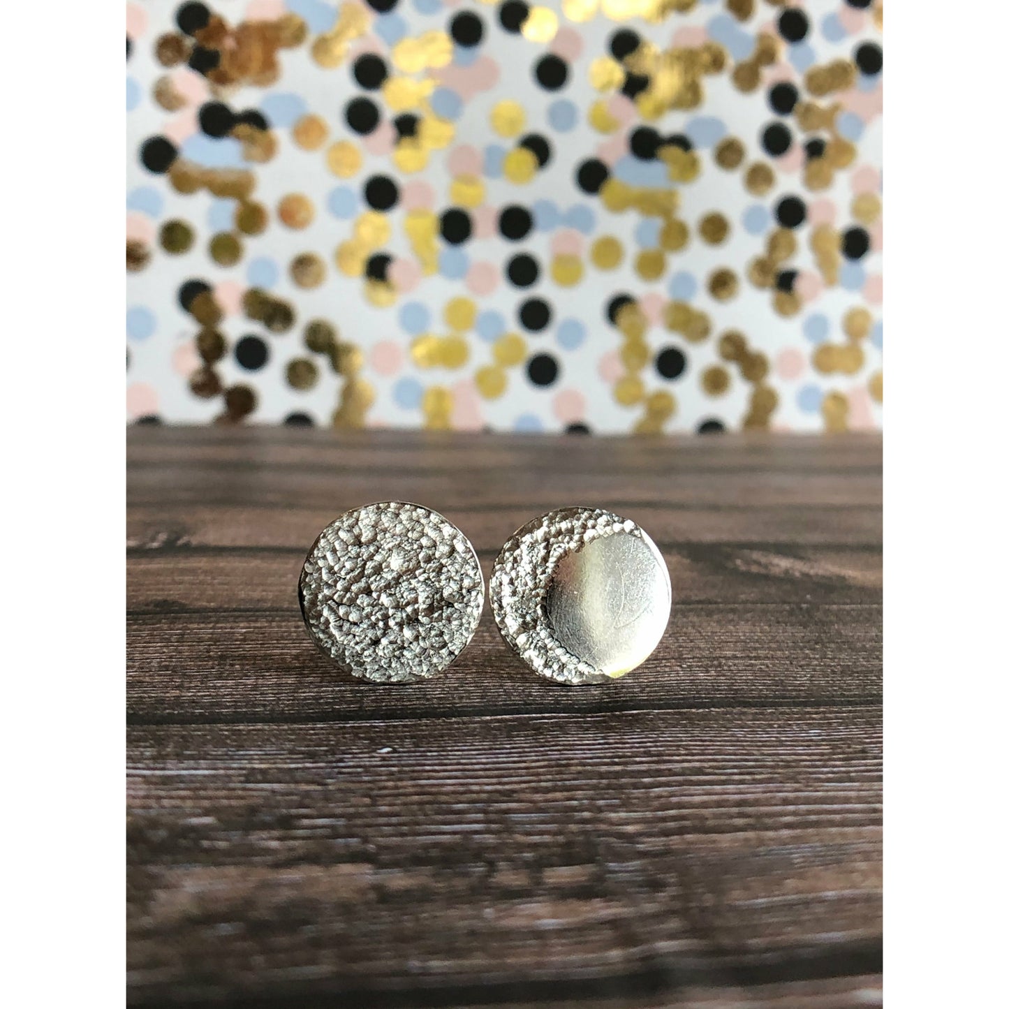 Circle pieces of silver with a crescent moon textured into each earrings. Center post