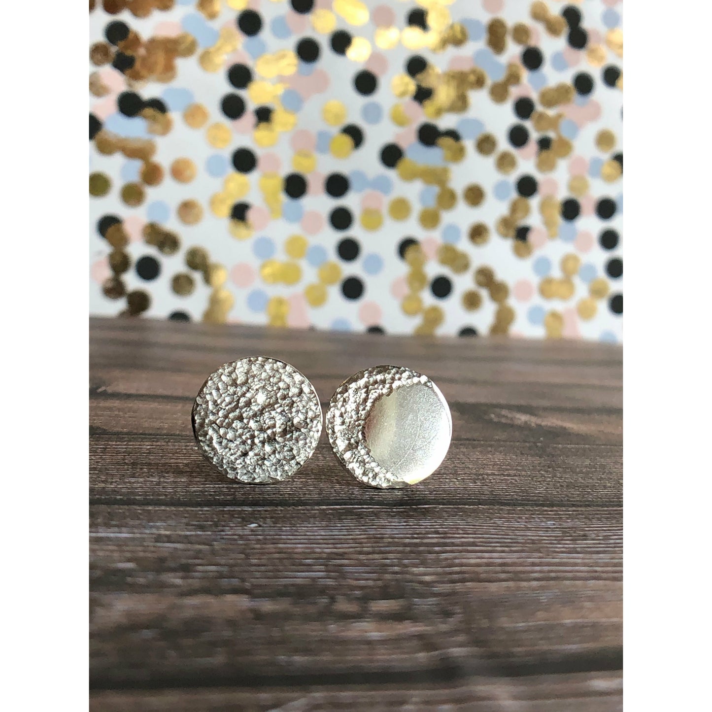 Circle pieces of silver with a crescent moon textured into each earrings. Center post