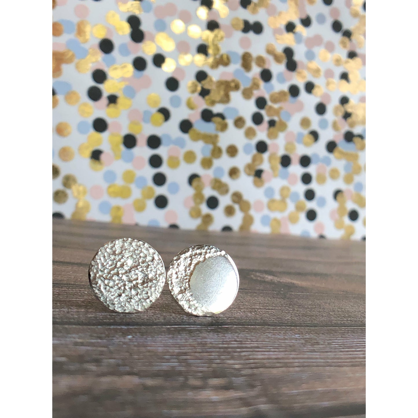 Circle pieces of silver with a crescent moon textured into each earrings. Center post