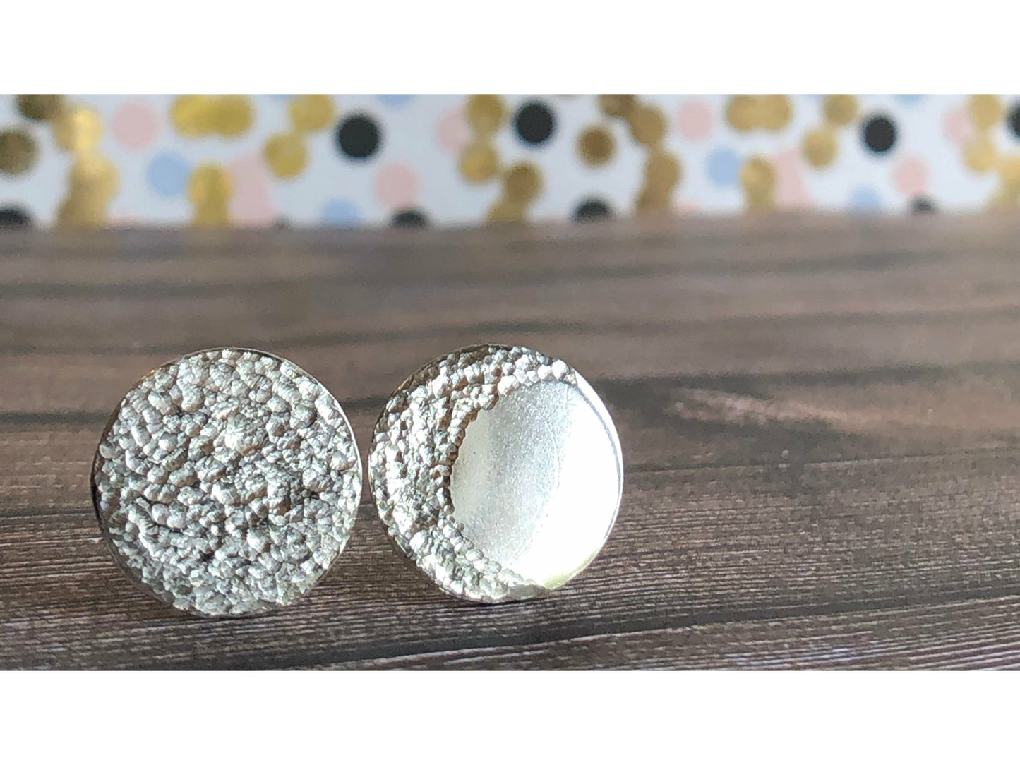 Circle pieces of silver with a crescent moon textured into each earrings. Center post