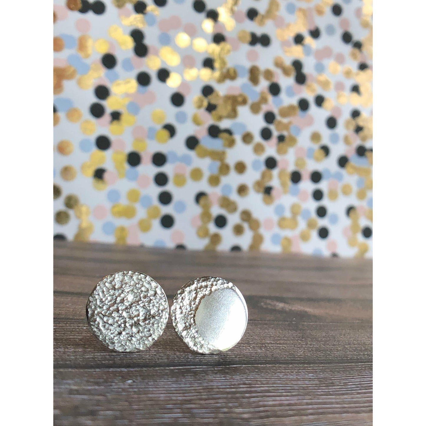 Circle pieces of silver with a crescent moon textured into each earrings. Center post