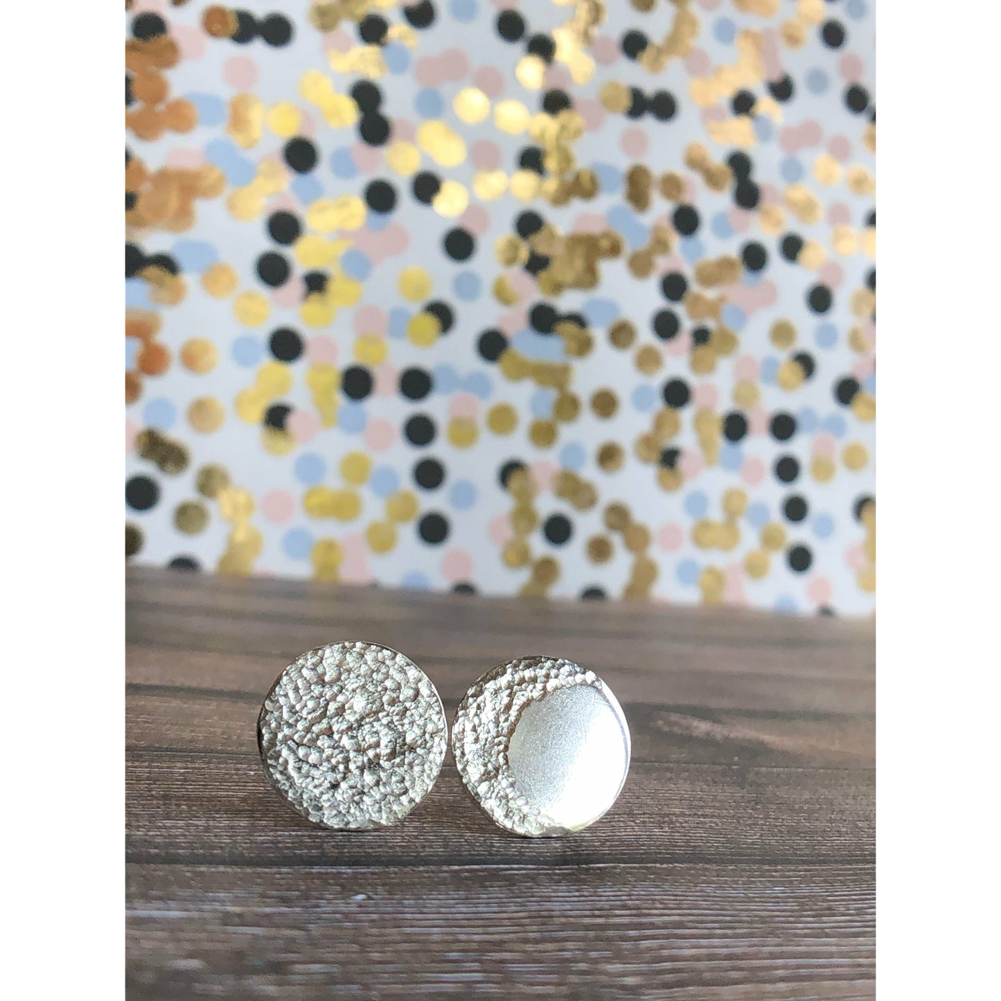 Circle pieces of silver with a crescent moon textured into each earrings. Center post