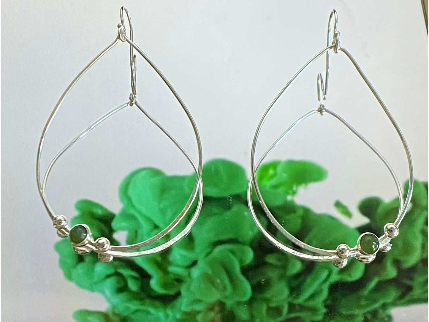 Teardrop gold or silver earrings with two dots of silver or gold offset to the left with a jade 3mm stone. Offset to the right in the right earring