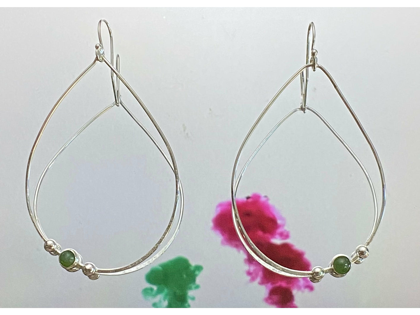 Teardrop gold or silver earrings with two dots of silver or gold offset to the left with a jade 3mm stone. Offset to the right in the right earring