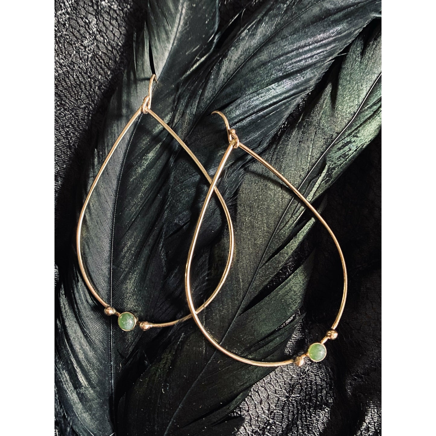 Teardrop gold or silver earrings with two dots of silver or gold offset to the left with a jade 3mm stone. Offset to the right in the right earring