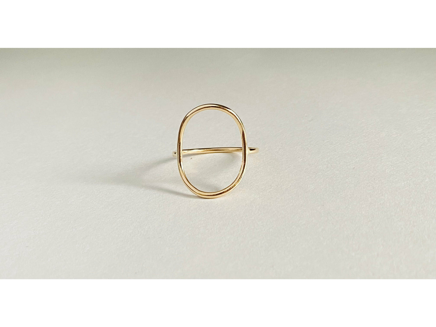 Gold filled oval ring with band attaching to either side of oval