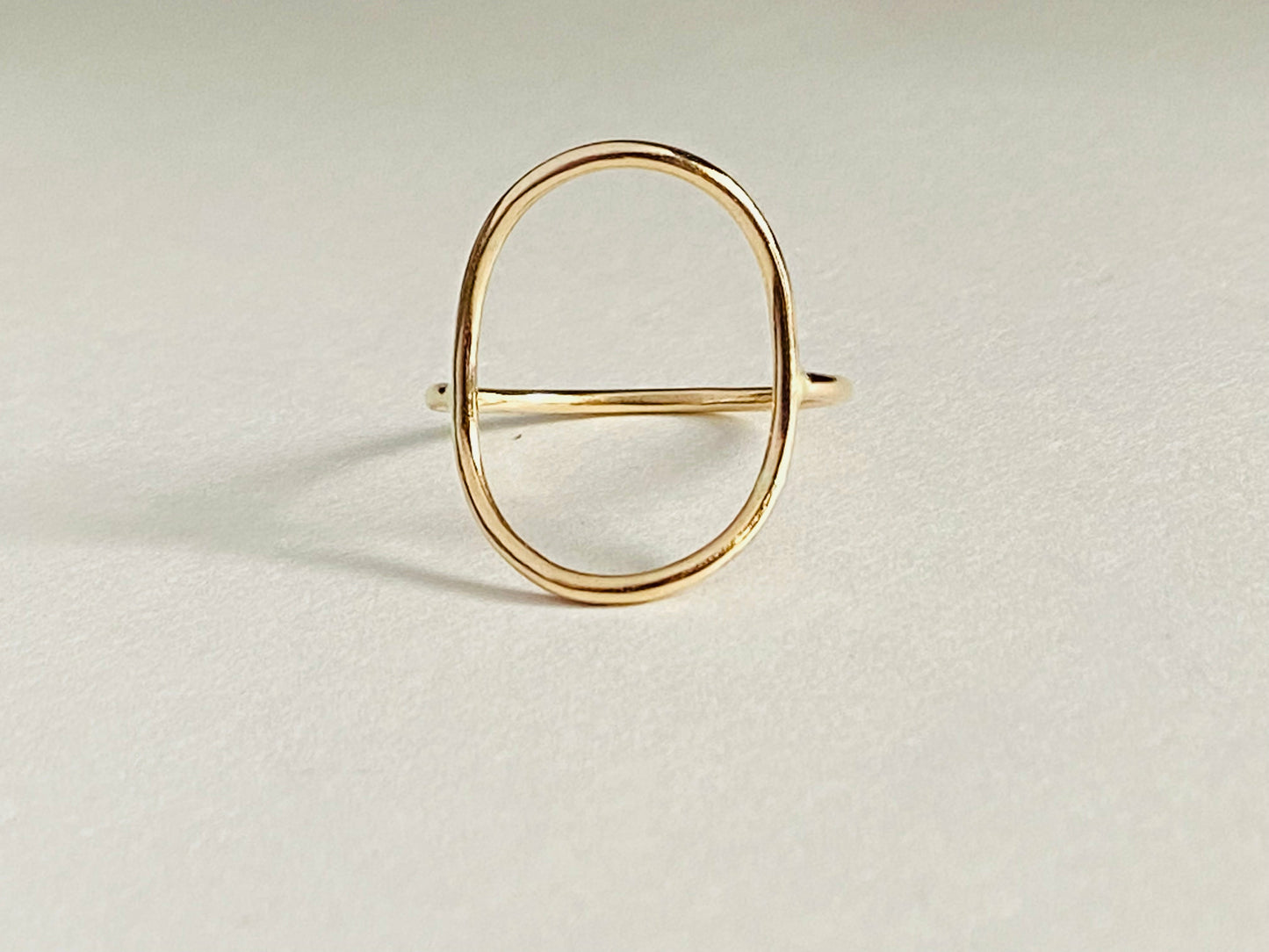 Gold filled oval ring with band attaching to either side of oval