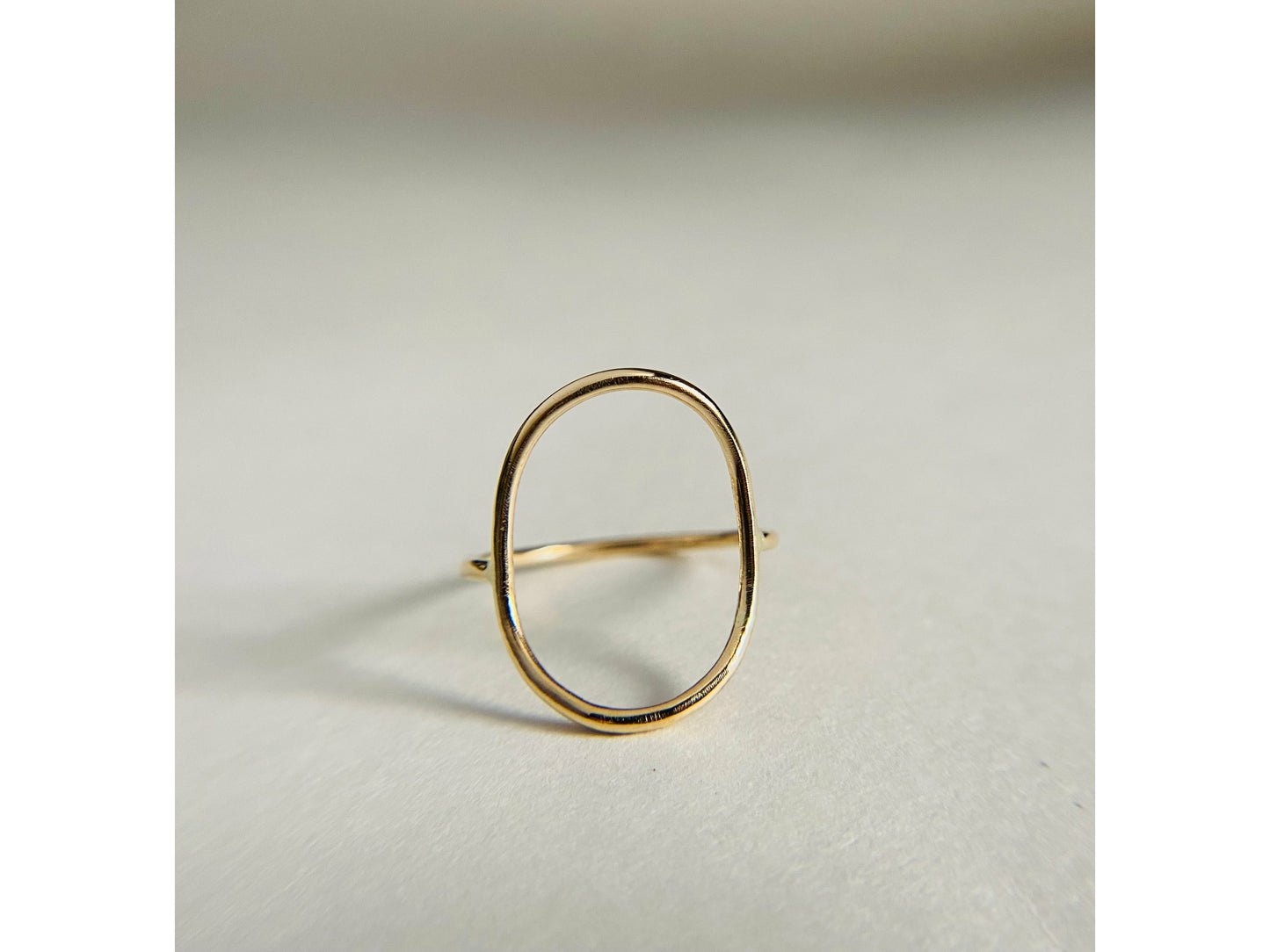 Gold filled oval ring with band attaching to either side of oval