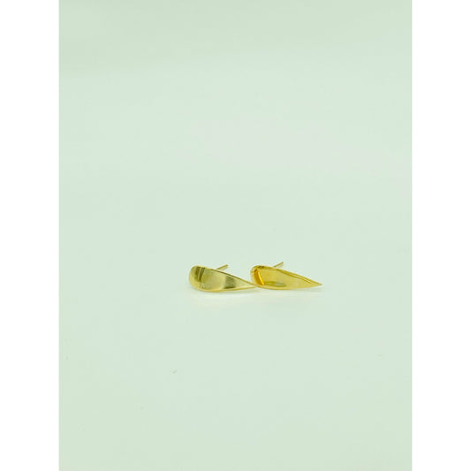 Gold spike earrings with point facing down.