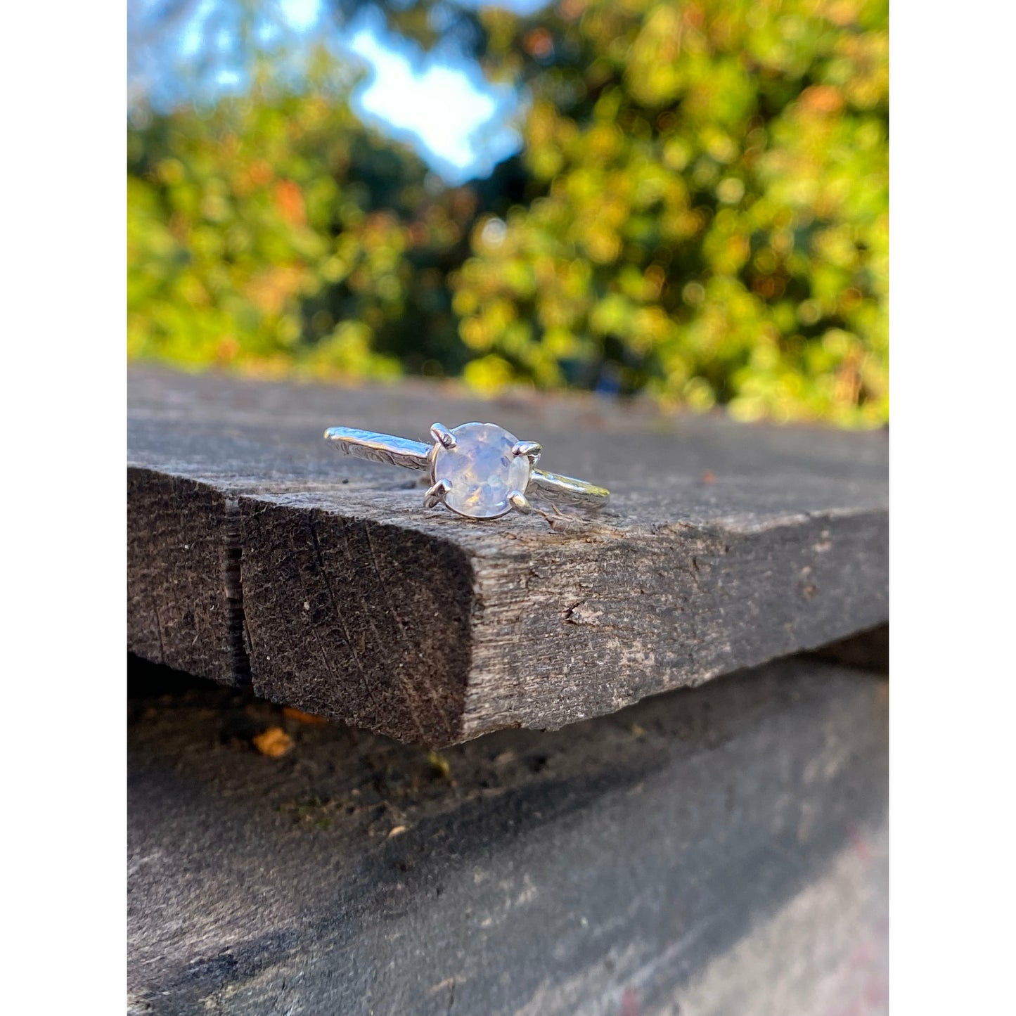 Moonstone prong set into a square simple band.