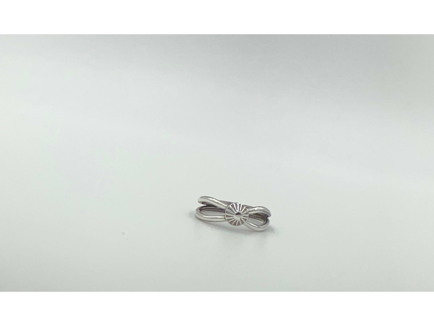 Split shank ring with center focal of a spiral ornated silver pendent. Small and dainty