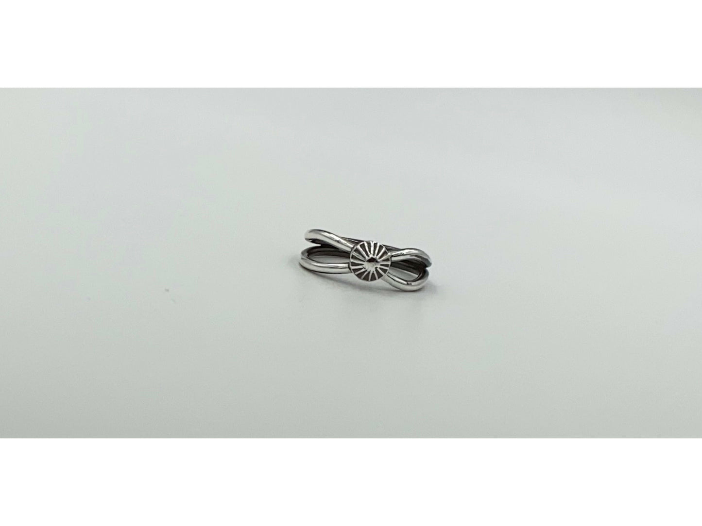 Split shank ring with center focal of a spiral ornated silver pendent. Small and dainty