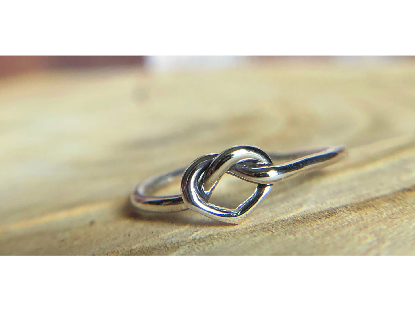 small heart formed out of silver, one continous piece of silver.