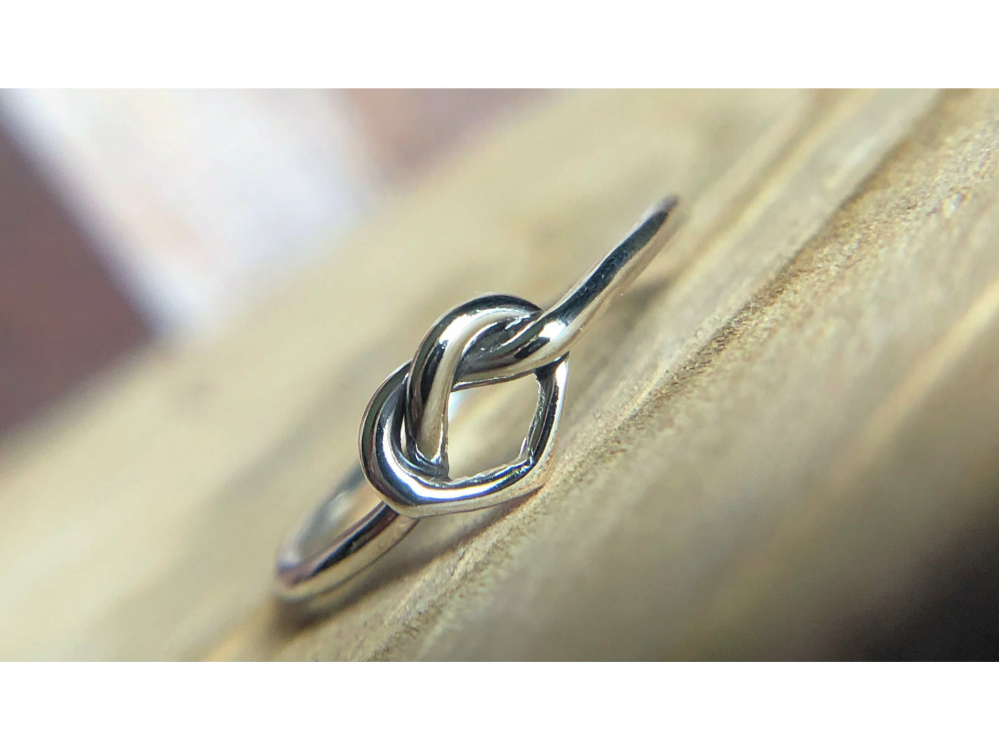 small heart formed out of silver, one continous piece of silver.