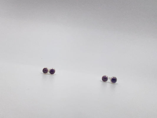 Small amethyst studs with closed back bezel.
