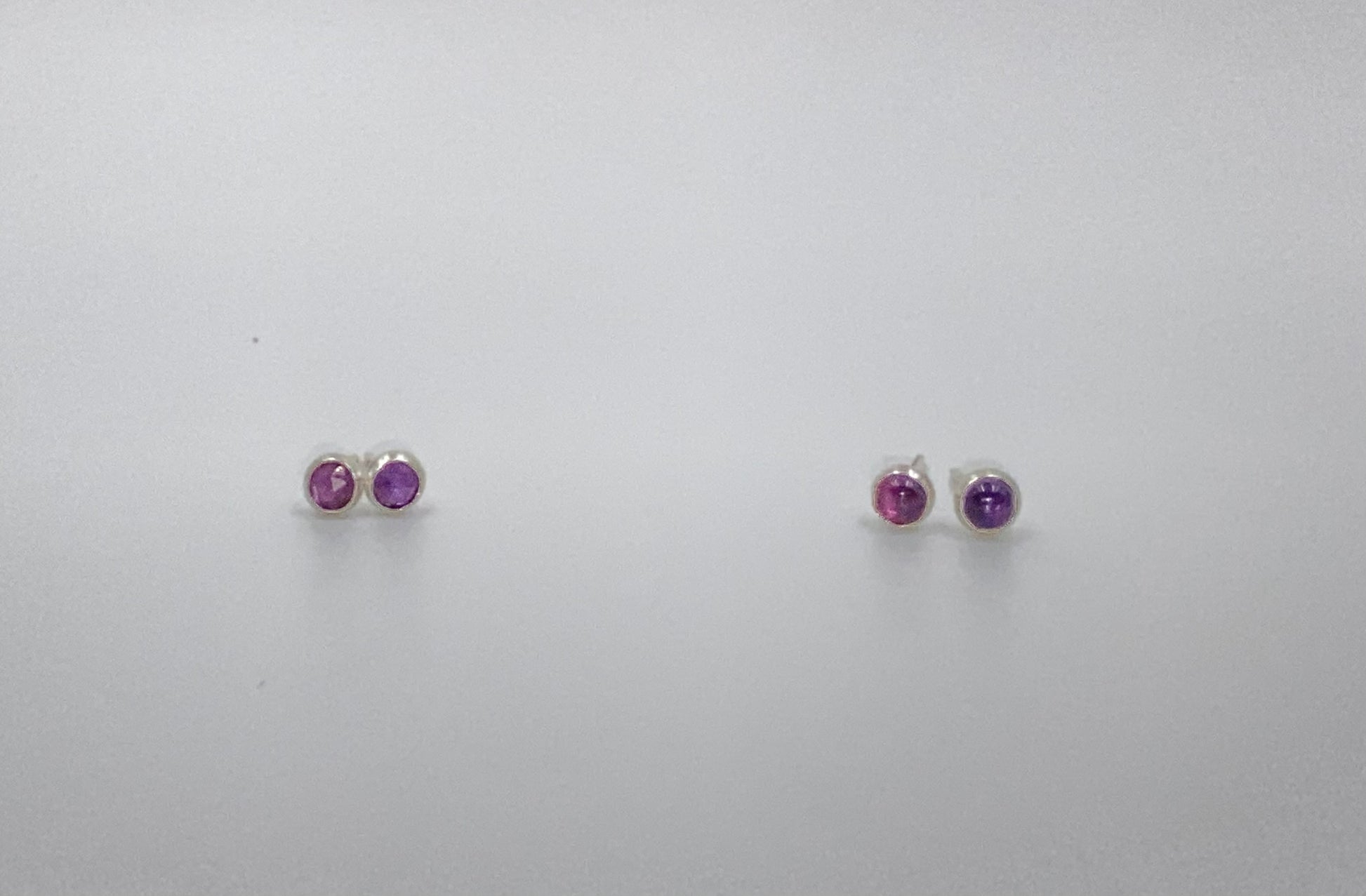 Small amethyst studs with closed back bezel. 