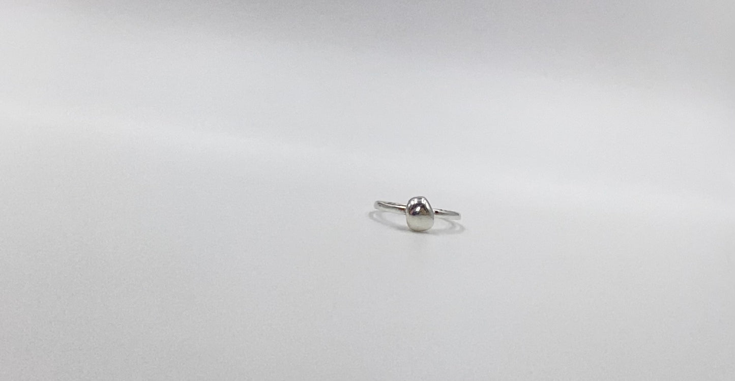 Organic sterling silver ring with large bump of silver resembling a raindrop as the focal, super simple straight band.