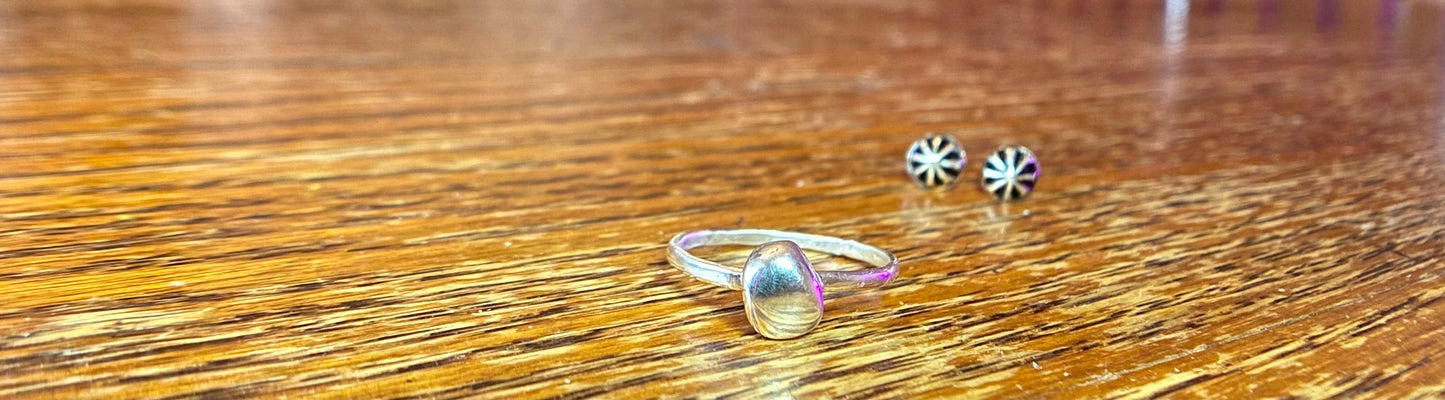 Organic sterling silver ring with large bump of silver resembling a raindrop as the focal, super simple straight band.