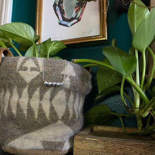 Minimal necklaces with your choice of small pieces of silver hammered out and soldered together to make a small circle line across the necklace.