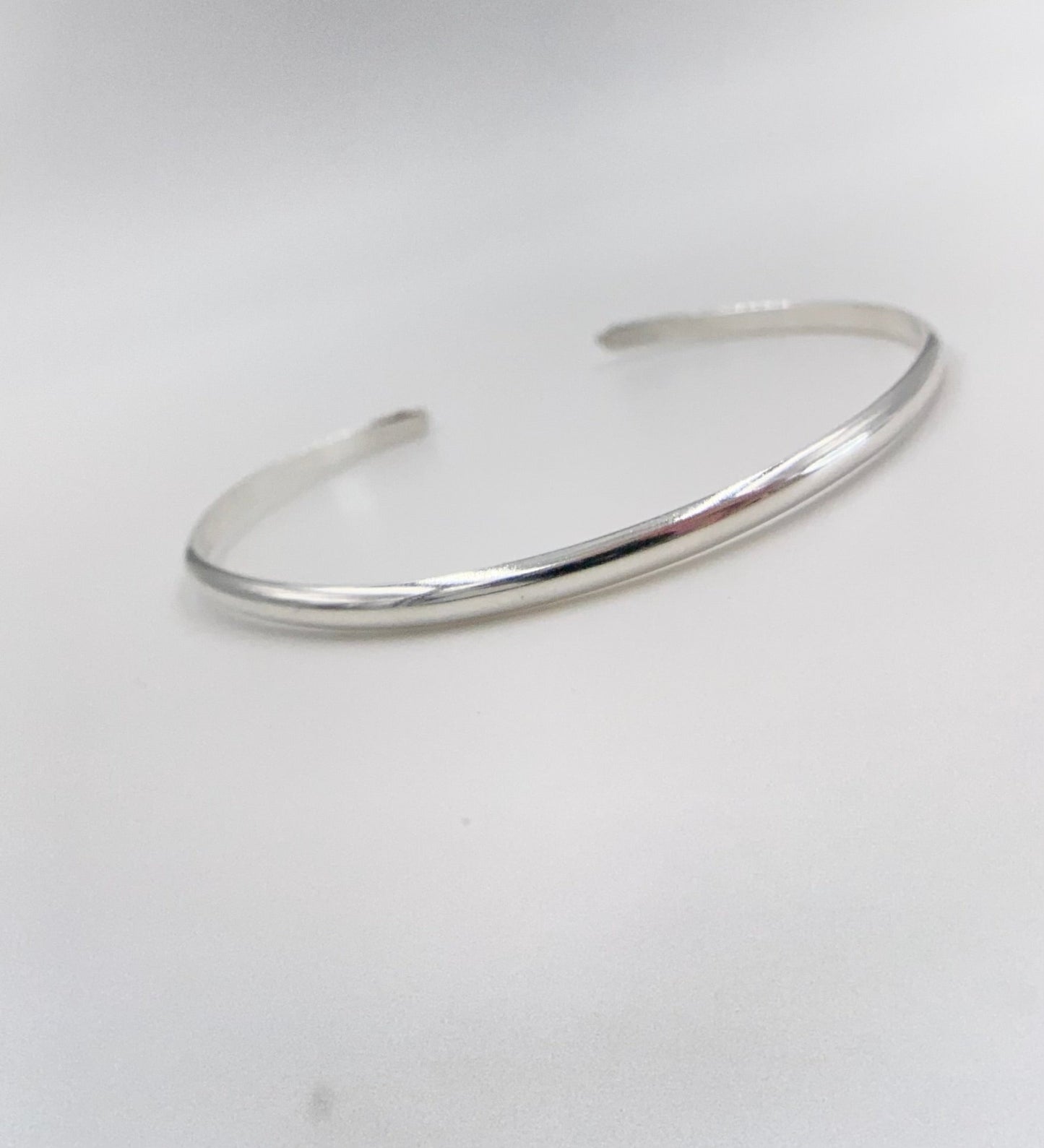 Stacakble cuffs with onyx, lapis or just a plain bracelet. Ornate pieces of silver dot the pieces as well as a oval stone.