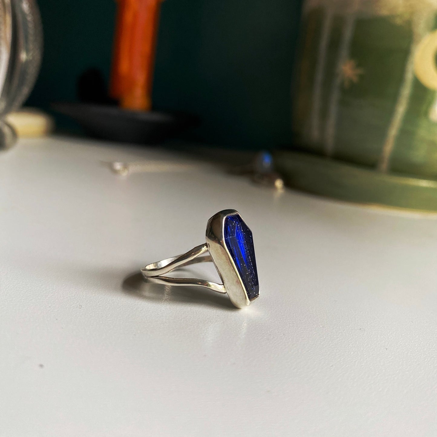 Blue coffin stone threaded with silver and gold through the stone. Split shank size 7 1/4