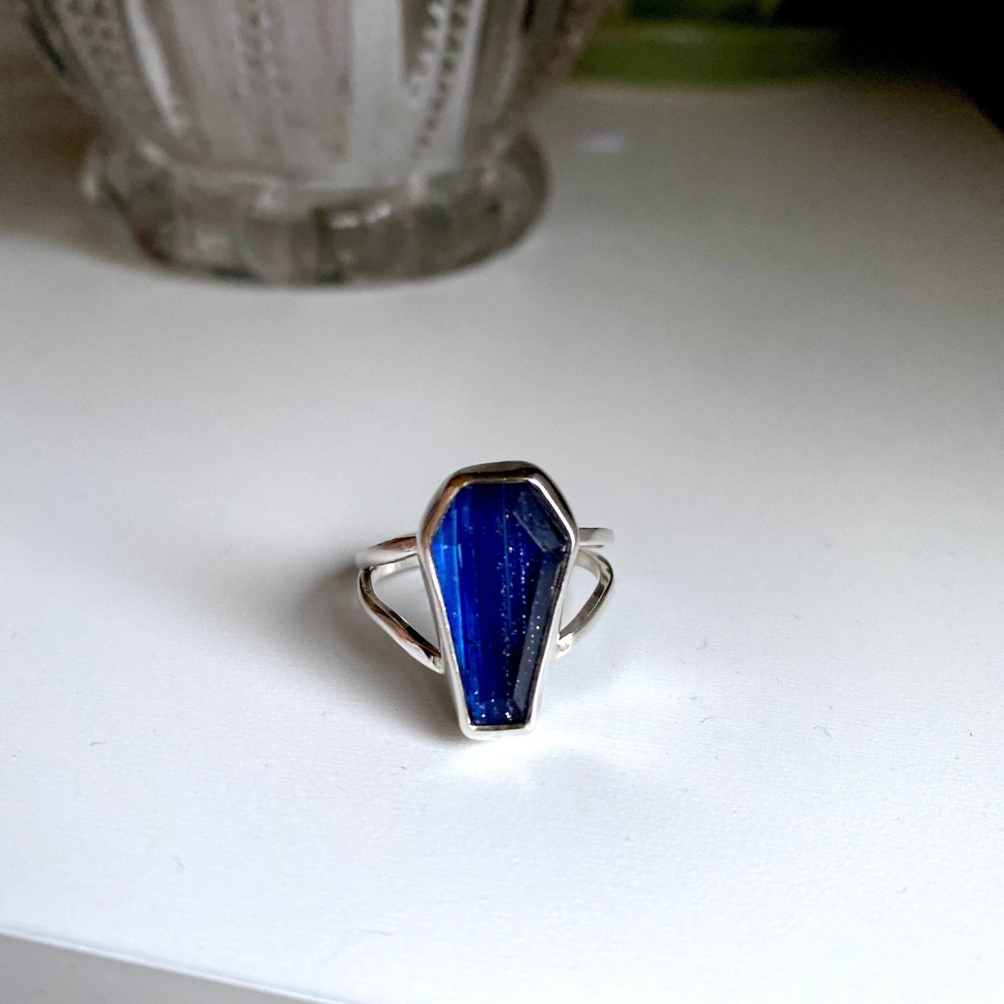 Blue coffin stone threaded with silver and gold through the stone. Split shank size 7 1/4